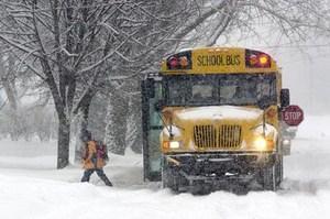 Bus dropping off a student during a snowstorm